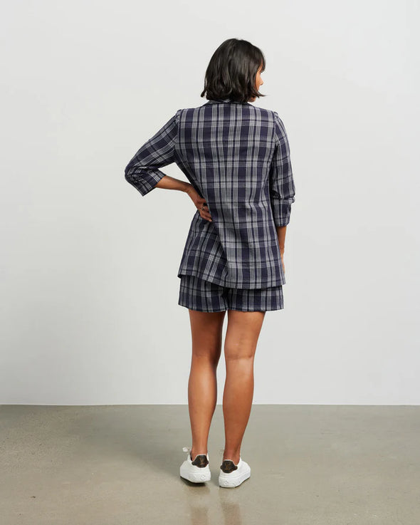 Blazers are having a big moment in fashion, and this style is on-trend with a slight masculine cut and longer length. This chic summer blazer is crafted in cotton blend plaid fabric and is fully lined, and the shorter length sleeves with tucked pleats at the elbow give it a relaxed vibe.

COLOUR
Ink Plaid

FABRIC INFO
80% Cotton 20% Poly