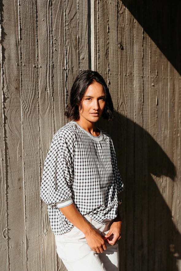 Best-selling easy fit top updated in a check print

Contrast striped rib neck and cuffs for a luxe finish

Playful monochrome design for versatile styling

Crafted from a comfortable 94% Polyester, 6% Spandex blend

A wardrobe must-have for easy, everyday chic