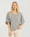 Best-selling easy fit top updated in a check print

Contrast striped rib neck and cuffs for a luxe finish

Playful monochrome design for versatile styling

Crafted from a comfortable 94% Polyester, 6% Spandex blend

A wardrobe must-have for easy, everyday chic