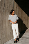 Best-selling easy fit top updated in a check print

Contrast striped rib neck and cuffs for a luxe finish

Playful monochrome design for versatile styling

Crafted from a comfortable 94% Polyester, 6% Spandex blend

A wardrobe must-have for easy, everyday chic