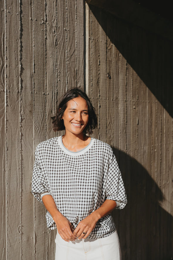 Best-selling easy fit top updated in a check print

Contrast striped rib neck and cuffs for a luxe finish

Playful monochrome design for versatile styling

Crafted from a comfortable 94% Polyester, 6% Spandex blend

A wardrobe must-have for easy, everyday chic