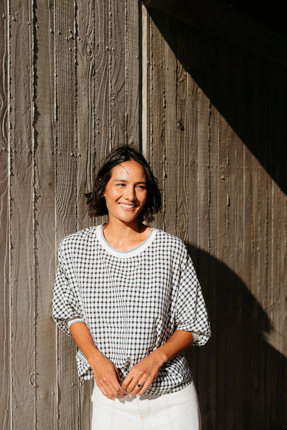 Best-selling easy fit top updated in a check print

Contrast striped rib neck and cuffs for a luxe finish

Playful monochrome design for versatile styling

Crafted from a comfortable 94% Polyester, 6% Spandex blend

A wardrobe must-have for easy, everyday chic
