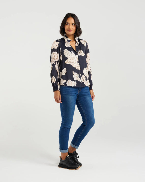 The Evelyn Blouse in Honeydew is a perfect combination of beautiful design and pretty print. It boasts a split V-neckline with a ruffle neckline, sheer full-length sleeves with gathered detail, and elastic hems. The fully lined body adds the perfect finishing touch. Dress it up or down for any occasion - The top that will not only meet the brief for 'jeans and a nice top' it will have you go from the office to the wine bar without skipping a beat!