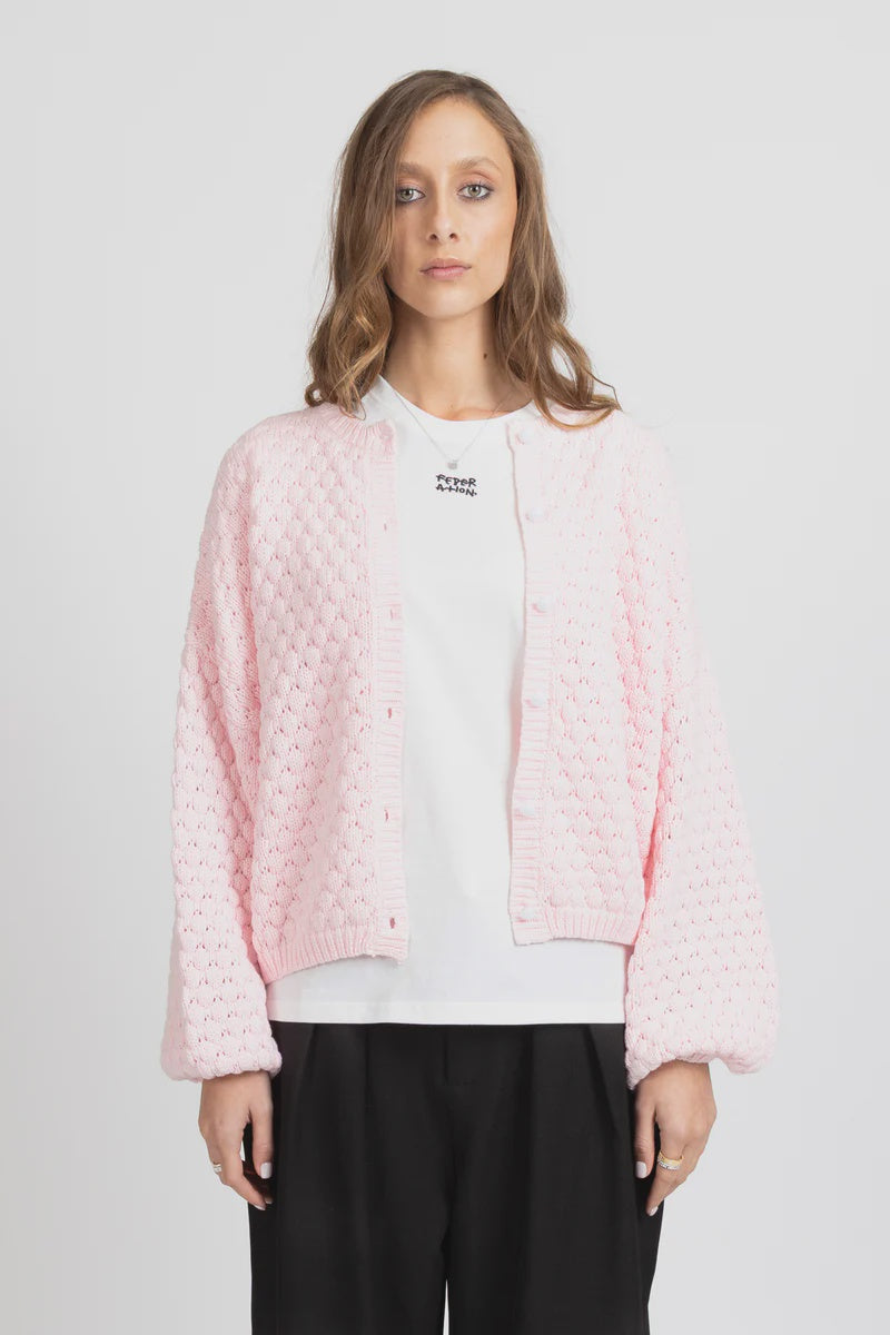 Textured honeycomb knit for added dimension
Relaxed oversized fit for effortless styling
Statement balloon sleeves
Elegant pearl button front closure
Wear open as a layer or closed as a knit top
Slightly cropped length for modern proportions
Designed in New Zealand by Federation
Oversized fit
Take your usual size for a relaxed look, or size down for a neater fit
60% Cotton 40% Acrylic