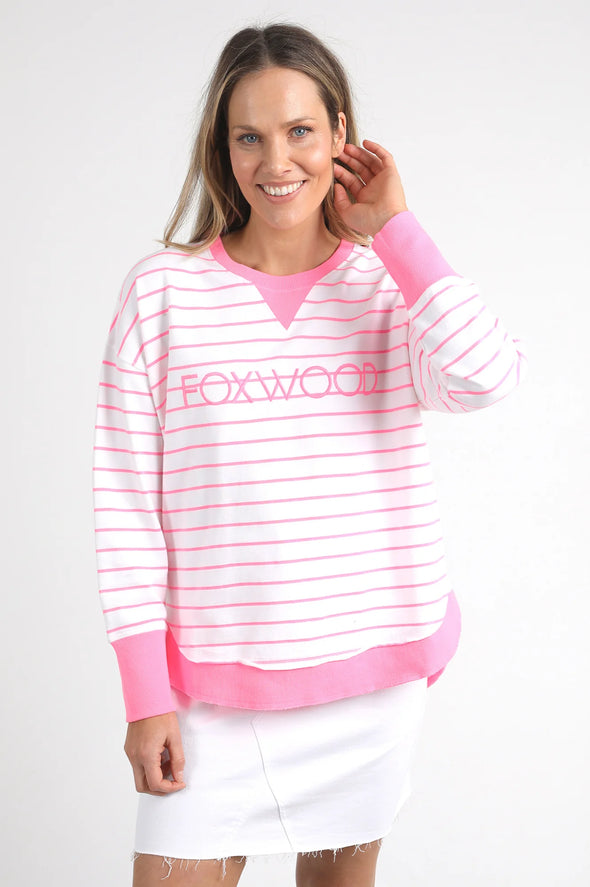 Meet your new go-to layer....The Foxwood Simplified Crew in Neon Pink Stripe. This vibrant piece is designed for effortless style and comfort, making it a must-have addition to your casual wardrobe. The crew features a relaxed round neck, trendy hi-lo hemline with side splits, and raw edge detailing that adds a touch of edge to your everyday looks. The embroidered Foxwood logo across the chest elevates the overall design, giving it that signature appeal.