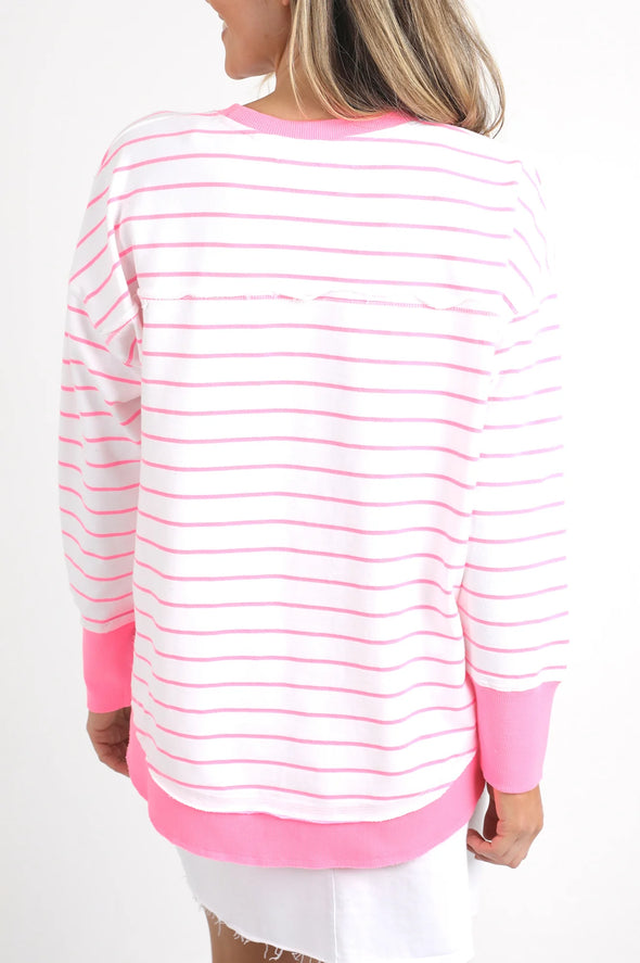 Meet your new go-to layer....The Foxwood Simplified Crew in Neon Pink Stripe. This vibrant piece is designed for effortless style and comfort, making it a must-have addition to your casual wardrobe. The crew features a relaxed round neck, trendy hi-lo hemline with side splits, and raw edge detailing that adds a touch of edge to your everyday looks. The embroidered Foxwood logo across the chest elevates the overall design, giving it that signature appeal.