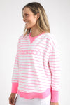 Meet your new go-to layer....The Foxwood Simplified Crew in Neon Pink Stripe. This vibrant piece is designed for effortless style and comfort, making it a must-have addition to your casual wardrobe. The crew features a relaxed round neck, trendy hi-lo hemline with side splits, and raw edge detailing that adds a touch of edge to your everyday looks. The embroidered Foxwood logo across the chest elevates the overall design, giving it that signature appeal.