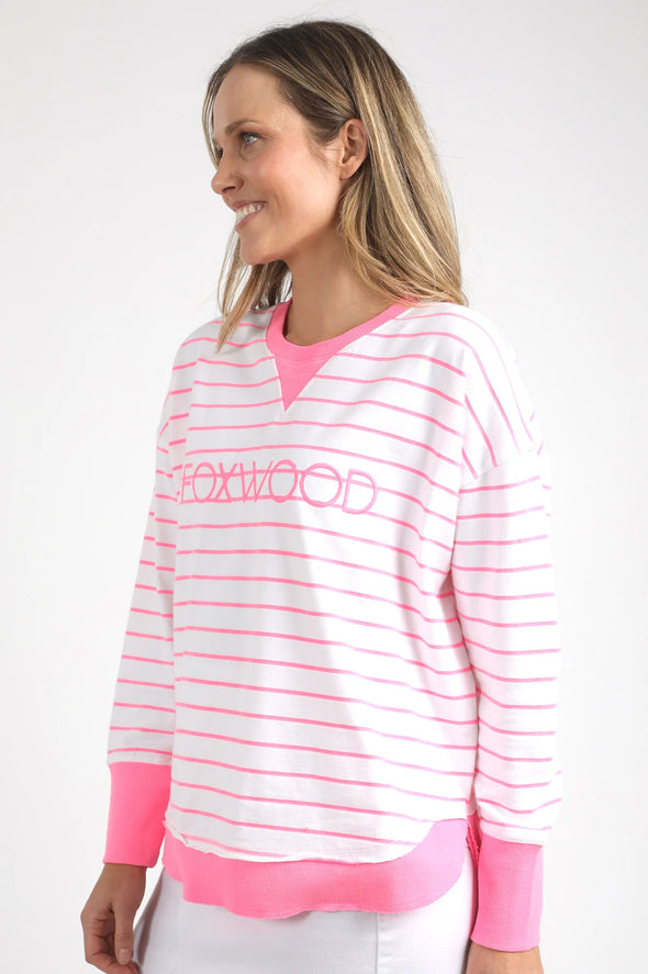 Meet your new go-to layer....The Foxwood Simplified Crew in Neon Pink Stripe. This vibrant piece is designed for effortless style and comfort, making it a must-have addition to your casual wardrobe. The crew features a relaxed round neck, trendy hi-lo hemline with side splits, and raw edge detailing that adds a touch of edge to your everyday looks. The embroidered Foxwood logo across the chest elevates the overall design, giving it that signature appeal.