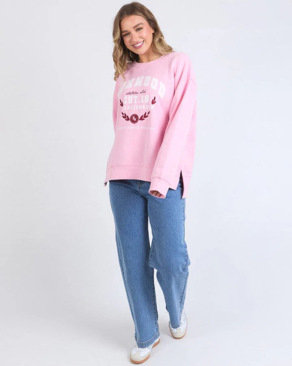 Snuggle up in style with Foxwood's Women's Pink Sweatshirt! The eye-catching "Foxwood" logo adds just the right amount of sass to this ultra-cozy essential. Crafted from fabric so soft you'll want to live in it, this pretty-in-pink number transitions effortlessly from Netflix marathons to coffee dates. Warning: Friends may experience extreme outfit envy when you rock this with your go-to leggings or jeans!