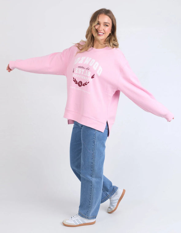 Snuggle up in style with Foxwood's Women's Pink Sweatshirt! The eye-catching "Foxwood" logo adds just the right amount of sass to this ultra-cozy essential. Crafted from fabric so soft you'll want to live in it, this pretty-in-pink number transitions effortlessly from Netflix marathons to coffee dates. Warning: Friends may experience extreme outfit envy when you rock this with your go-to leggings or jeans!