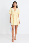 Get ready to indulge in the buttery softness of this yellow mini dress! Its playful tiered design and elastic waist provide both a comfortable fit and a feminine look. With a v neckline and drapey puff sleeves, this dress flatters your silhouette. And don't forget the charming bow and open back for added flair!