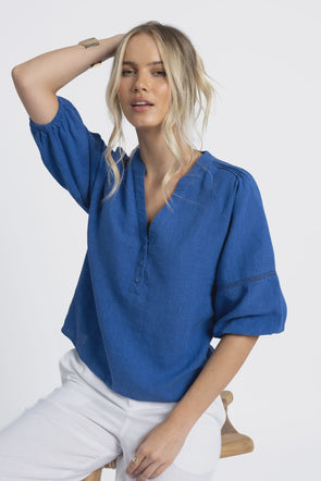 Crafted from a breathable, eco-friendly linen, cotton ramie, and tencel blend

Flattering V-neckline with self-covered button closure

Pintuck detailing on shoulders for subtle texture

Roomy sleeves with trim and elastic cuffs for versatile styling

Relaxed fit pairs easily with jeans, shorts, or linen pants