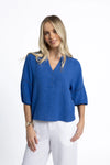 Crafted from a breathable, eco-friendly linen, cotton ramie, and tencel blend

Flattering V-neckline with self-covered button closure

Pintuck detailing on shoulders for subtle texture

Roomy sleeves with trim and elastic cuffs for versatile styling

Relaxed fit pairs easily with jeans, shorts, or linen pants