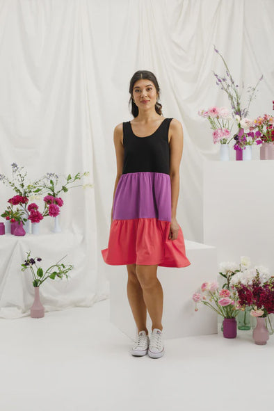 Introducing the Mischa Dress - a must-have Summer essential that radiates fun and flirtiness. Crafted from a blend of soft Cotton and stretchy Elastane, it boasts a singlet style top with a rounded neckline and a scooped back, descending into a tiered skirt with convenient pockets. And that's not all - this dress is available in our custom dyed shades of Orchid and Berry, adding a dazzling splash of color to your wardrobe. Get ready to effortlessly turn heads!