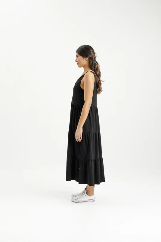 Get ready for summer with the Maddie Dress! This comfortable dress is made from a stretchy Cotton/Elastane fabric and features a rounded neckline that dips lower in the back. Complete with pockets and a full tiered hem skirt, this dress flatters all body types. The thicker singlet straps make it easy to wear any bra, no fuss!