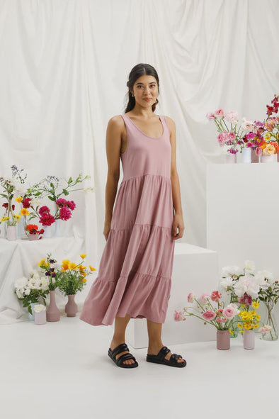 Get ready for summer with the Maddie Dress! This comfortable dress is made from a stretchy Cotton/Elastane fabric and features a rounded neckline that dips lower in the back. Complete with pockets and a full tiered hem skirt, this dress flatters all body types. The thicker singlet straps make it easy to wear any bra, no fuss!