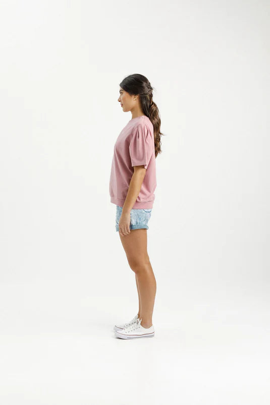 Experience ultimate comfort and style with our Wylder Tee. Featuring a gathered shoulder detail, a straight fit, and a ribbed hem, this tee is made from soft and stretchy Cotton/Elastane. The subtle raised X on the chest adds a charming touch to our custom Rouge color with a White X. Get ready to fall in love with this elevated essential.