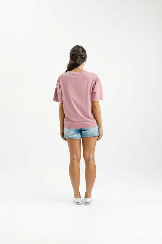 Experience ultimate comfort and style with our Wylder Tee. Featuring a gathered shoulder detail, a straight fit, and a ribbed hem, this tee is made from soft and stretchy Cotton/Elastane. The subtle raised X on the chest adds a charming touch to our custom Rouge color with a White X. Get ready to fall in love with this elevated essential.