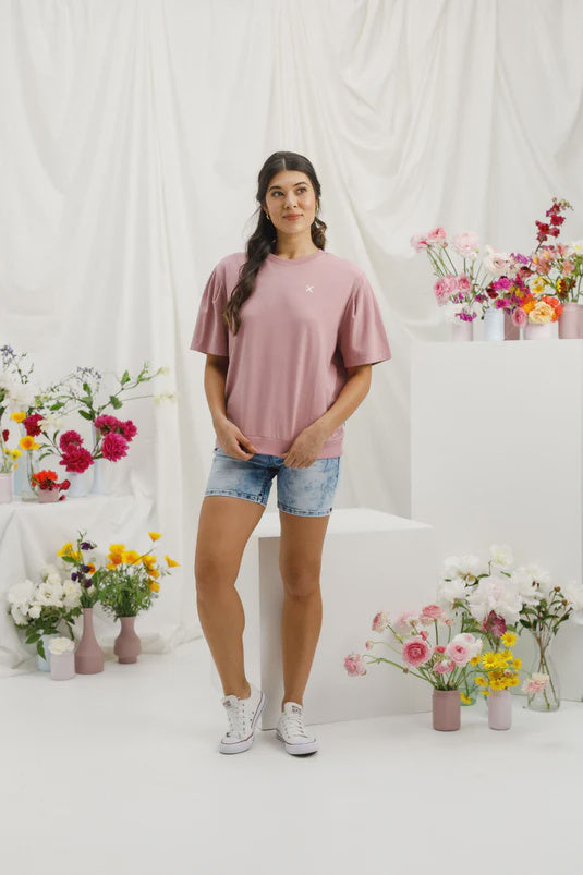 Experience ultimate comfort and style with our Wylder Tee. Featuring a gathered shoulder detail, a straight fit, and a ribbed hem, this tee is made from soft and stretchy Cotton/Elastane. The subtle raised X on the chest adds a charming touch to our custom Rouge color with a White X. Get ready to fall in love with this elevated essential.