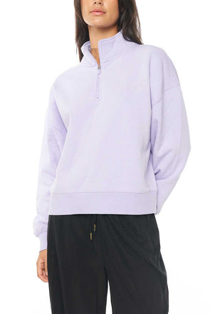 Get ready to snuggle up in style with the Huffer sweater in a beautiful lilac color. This cozy seater features a convenient 1/4 zip, allowing you to adjust the neckline to your liking. The fleece lining inside provides extra warmth and comfort, making it perfect for those chilly days.