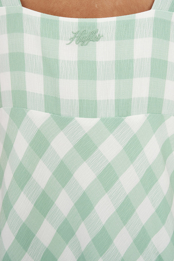 Refresh your wardrobe with the effortlessly chic Celine Midi Dress. A modern take on classic gingham, this piece features a fresh Matcha green and white diagonal check that feels both sophisticated and playful.