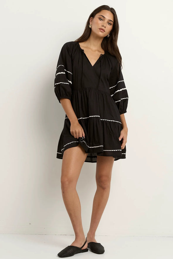 • Made from breathable 100% cotton
• Natural fibre for lightweight, airy comfort
• Tiered silhouette adds soft volume and flow
• Relaxed sleeves for casual ease
• Plain black design elevated with subtle trim detail