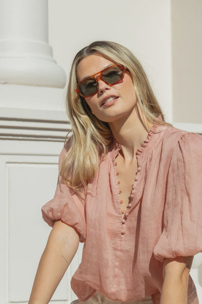 High neck blouse with frill detailing

Elegant button front design

Mid-length balloon sleeves for a feminine touch

Semi-sheer 100% Ramie fabric – lightweight and breathable

Effortless styling from day to night