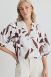 Elevate your wardrobe with the charming Ornamental Chocolate Leaves Lace Pintuck Shirt. Delicate lace inserts and playful pintuck details bring a whimsical touch to this classic shirt. Perfect for any occasion, add a unique twist to your outfit with this must-have piece.