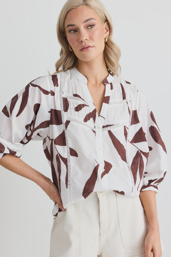 Elevate your wardrobe with the charming Ornamental Chocolate Leaves Lace Pintuck Shirt. Delicate lace inserts and playful pintuck details bring a whimsical touch to this classic shirt. Perfect for any occasion, add a unique twist to your outfit with this must-have piece.