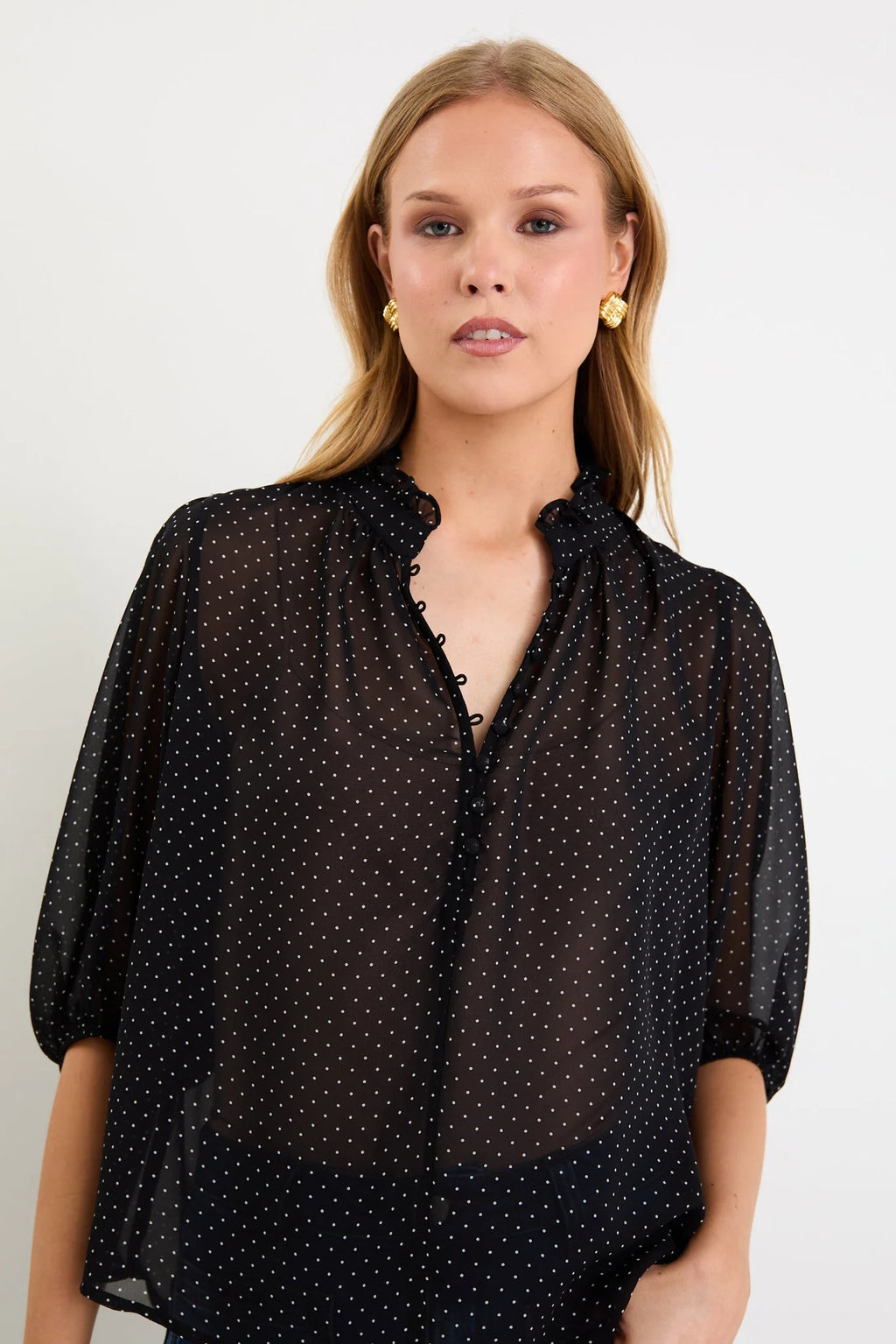 Elegant high neckline with delicate button-front detailing
Lightweight sheer fabrication with soft movement
Mid-length balloon sleeves for subtle volume
Timeless mini polka dot print
Relaxed, floaty silhouette designed for versatile styling
Easy to dress up or down
Fabric: 100% Polyester
