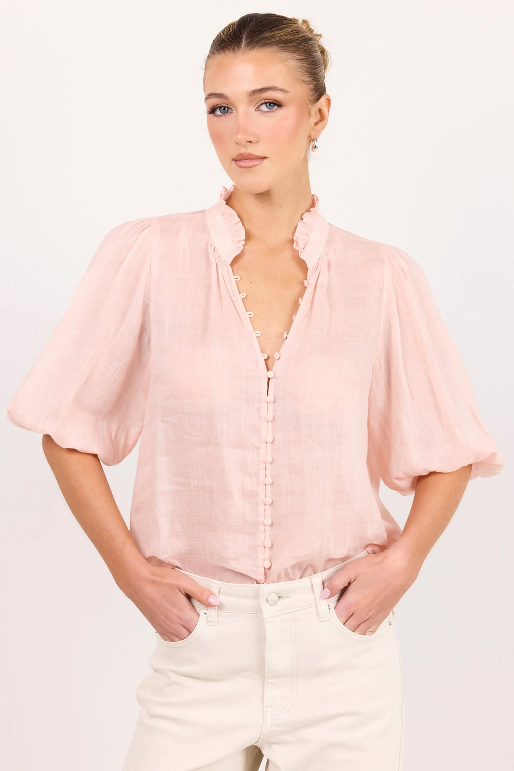 - Ruffled high neckline
- Mid-length balloon sleeves
- Covered button-front detail
- Relaxed silhouette
- Lightweight ramie fabrication
- Natural fibre
- Fabric Composition - 100% Ramie