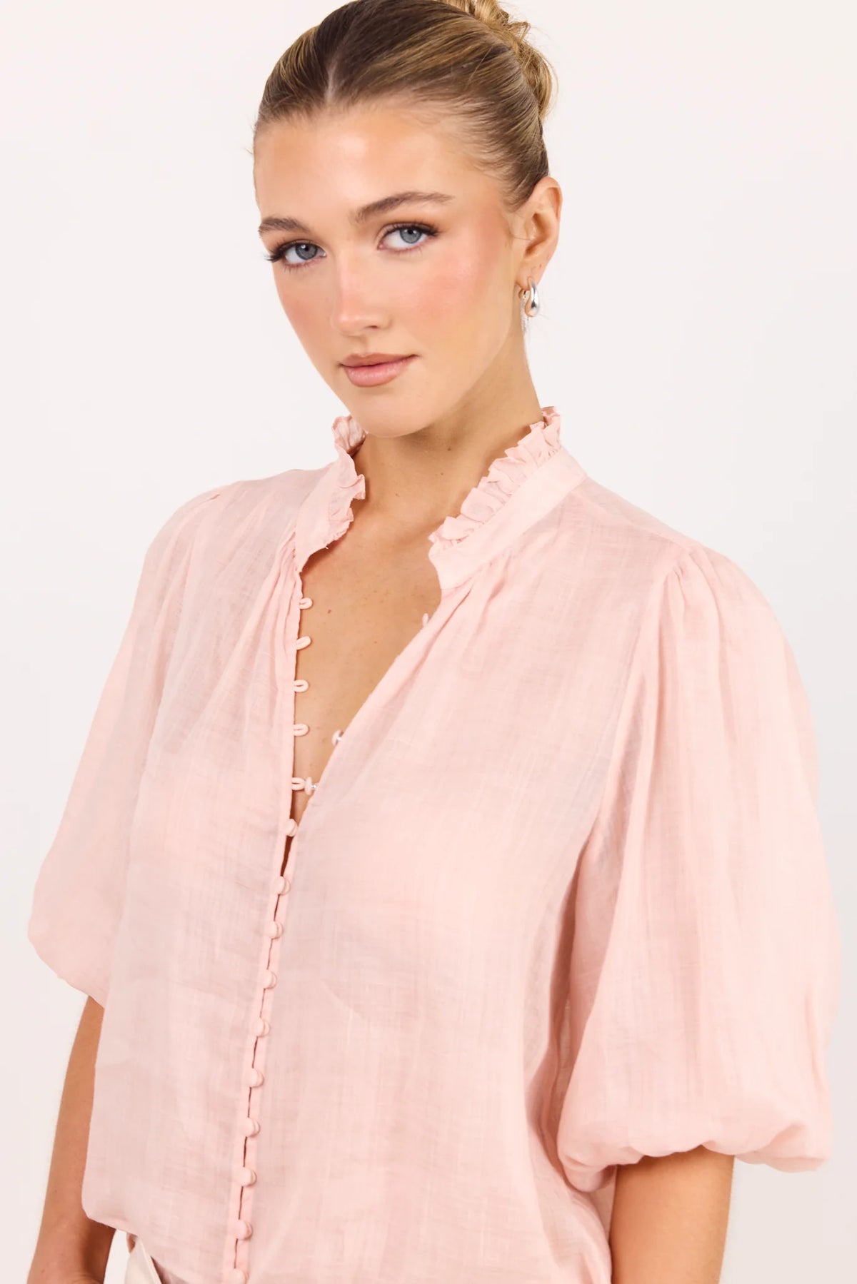 - Ruffled high neckline
- Mid-length balloon sleeves
- Covered button-front detail
- Relaxed silhouette
- Lightweight ramie fabrication
- Natural fibre
- Fabric Composition - 100% Ramie