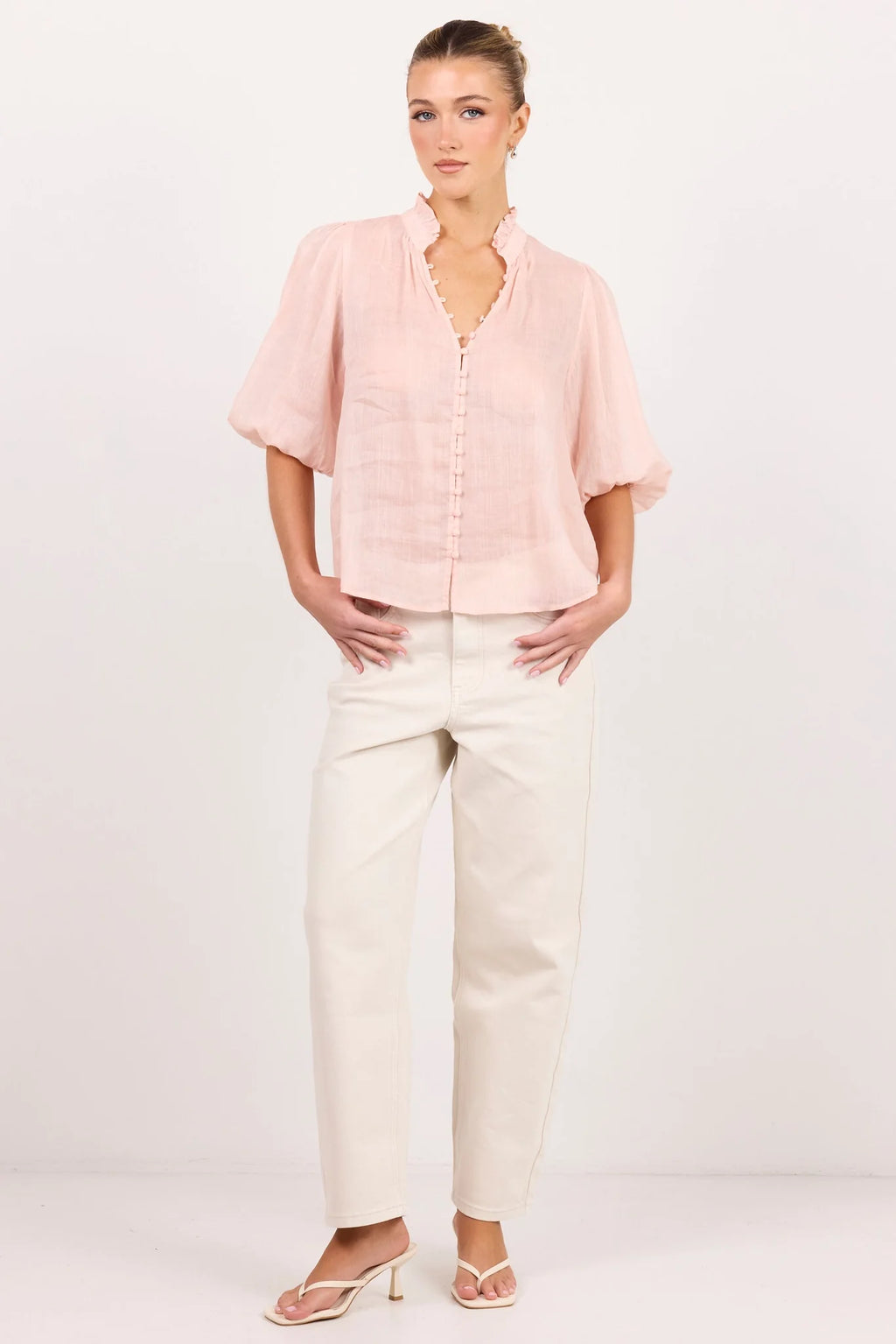 - Ruffled high neckline
- Mid-length balloon sleeves
- Covered button-front detail
- Relaxed silhouette
- Lightweight ramie fabrication
- Natural fibre
- Fabric Composition - 100% Ramie