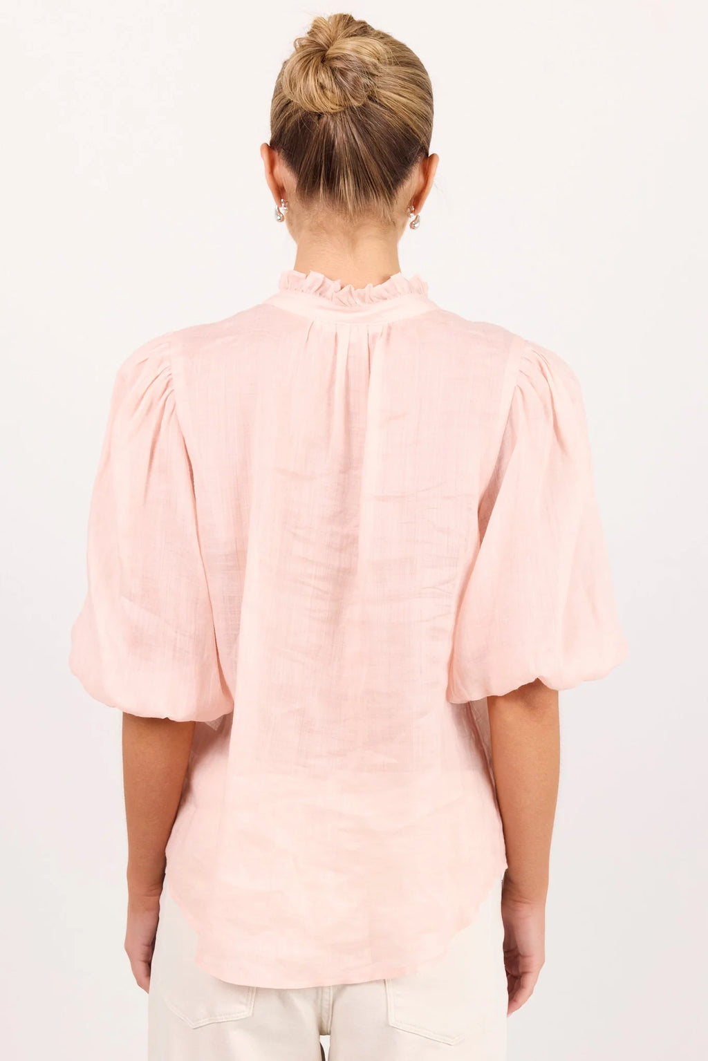 - Ruffled high neckline
- Mid-length balloon sleeves
- Covered button-front detail
- Relaxed silhouette
- Lightweight ramie fabrication
- Natural fibre
- Fabric Composition - 100% Ramie