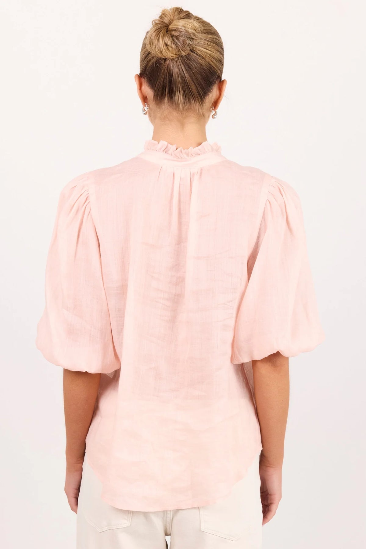 - Ruffled high neckline
- Mid-length balloon sleeves
- Covered button-front detail
- Relaxed silhouette
- Lightweight ramie fabrication
- Natural fibre
- Fabric Composition - 100% Ramie