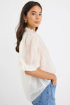 Start your day with a playful twist in the Closure Top. Featuring a high neck with charming frill details and a button front, this top also boasts mid-length balloon sleeves for added fun. Made from a semi-sheer linen blend, it offers breathable comfort that’s perfect for any occasion.