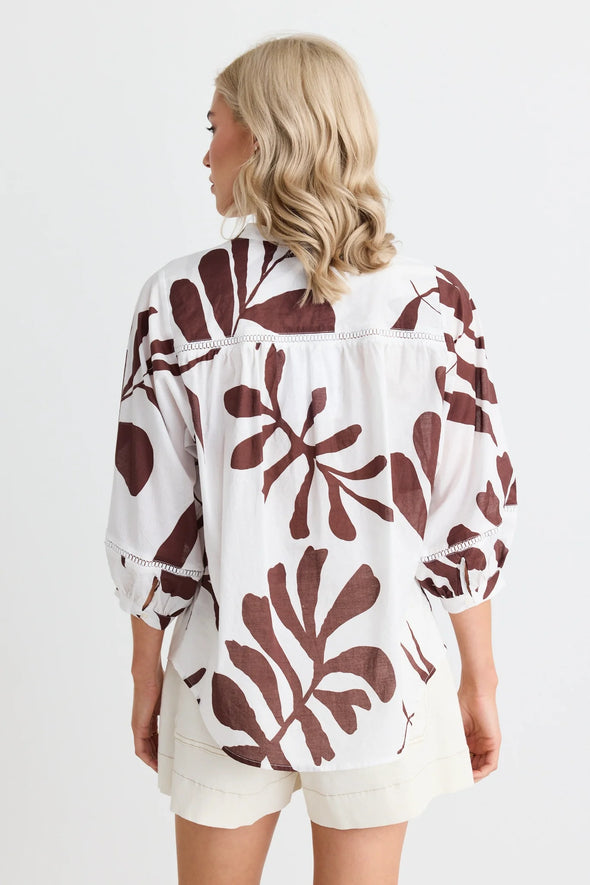 Elevate your wardrobe with the charming Ornamental Chocolate Leaves Lace Pintuck Shirt. Delicate lace inserts and playful pintuck details bring a whimsical touch to this classic shirt. Perfect for any occasion, add a unique twist to your outfit with this must-have piece.