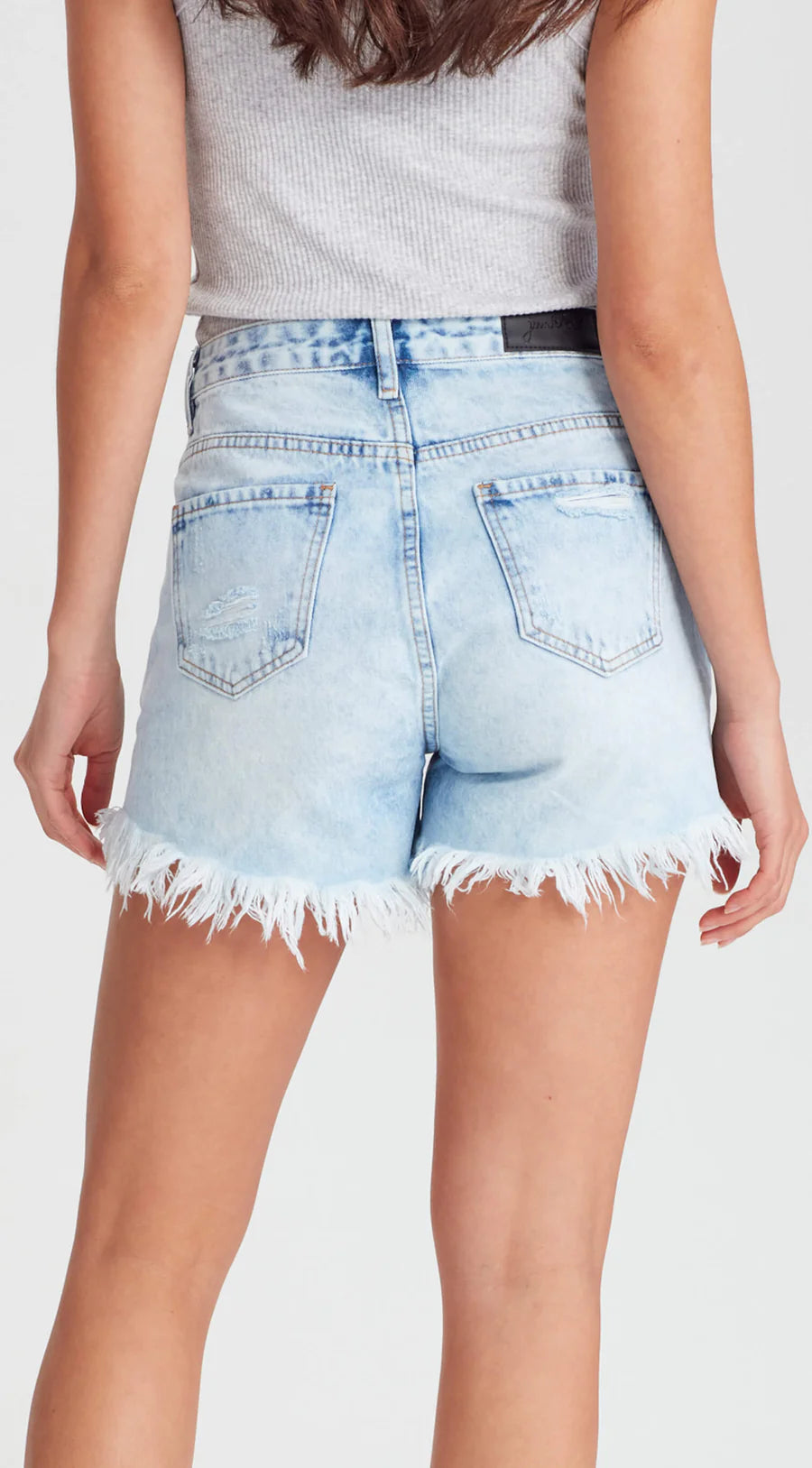 The famous Sofia shorts by Junkfood are always a fast seller and a real favourite. Perfectly distressed and a mid rise these look great fitted or looser and lower on the waist. Rigid but soft denim shorts with ripped front panels and a raw hem.

Fixed waist band with belt loops, 100% cotton, zip fly, classic 5 pocket design. Rips and holes will naturally continue to grow.