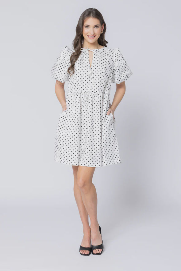 Relaxed silhouette with adjustable drawstring waist

Keyhole neckline with self-tie bow detail

Short puff sleeves for a modern, feminine look

Versatile mini length for year-round styling

Easy to dress up or down with boots, sneakers, or sandals