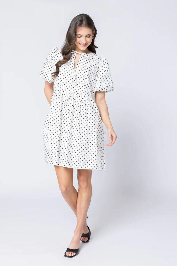 Relaxed silhouette with adjustable drawstring waist

Keyhole neckline with self-tie bow detail

Short puff sleeves for a modern, feminine look

Versatile mini length for year-round styling

Easy to dress up or down with boots, sneakers, or sandals