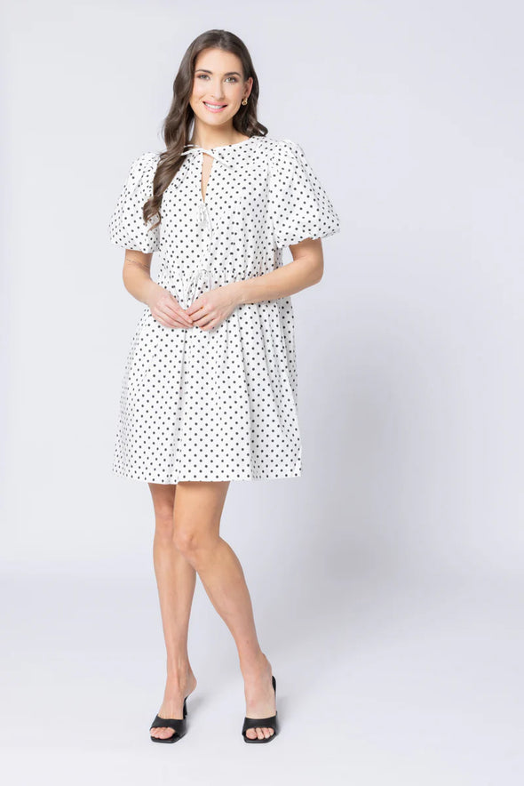 Relaxed silhouette with adjustable drawstring waist

Keyhole neckline with self-tie bow detail

Short puff sleeves for a modern, feminine look

Versatile mini length for year-round styling

Easy to dress up or down with boots, sneakers, or sandals
