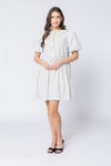 Relaxed silhouette with adjustable drawstring waist

Keyhole neckline with self-tie bow detail

Short puff sleeves for a modern, feminine look

Versatile mini length for year-round styling

Easy to dress up or down with boots, sneakers, or sandals
