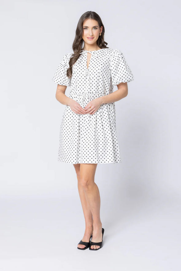 Relaxed silhouette with adjustable drawstring waist

Keyhole neckline with self-tie bow detail

Short puff sleeves for a modern, feminine look

Versatile mini length for year-round styling

Easy to dress up or down with boots, sneakers, or sandals