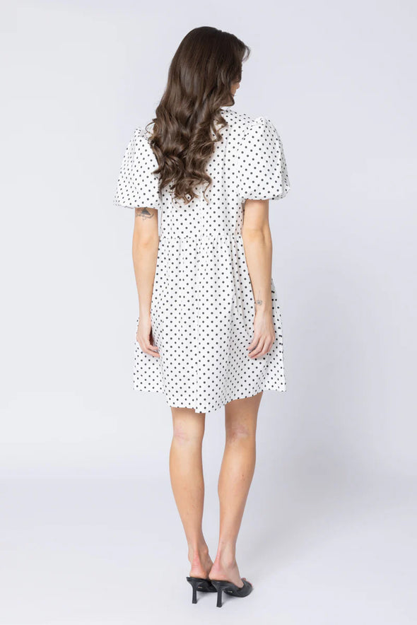 Relaxed silhouette with adjustable drawstring waist

Keyhole neckline with self-tie bow detail

Short puff sleeves for a modern, feminine look

Versatile mini length for year-round styling

Easy to dress up or down with boots, sneakers, or sandals