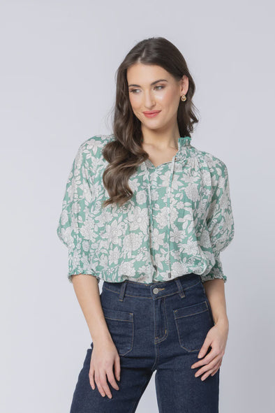 The Encourage Top by Leila + Luca brings effortless charm to your everyday wardrobe. Featuring a soft sage green base with a delicate white bloom print, this easy fit style is perfect for warmer days. With its relaxed shape and elbow length sleeves, it’s light, airy, and ideal for pairing with your favourite denim or linen pieces.