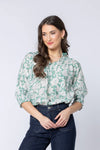 Pretty sage-green base with white bloom print

Relaxed, easy fit

Elbow-length sleeves

Lightweight and breathable

Perfect for pairing with jeans or summer skirts

Composition: 70% Viscose, 30% Nylon