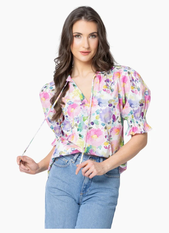 All-over patterned design

Gathered neckline for soft, feminine shaping

V-neckline with adjustable tie detail

Elasticated ruffle cuffs for a romantic finish

Standard fit with no stretch

Lightweight, floaty silhouette perfect for tucking or wearing loose