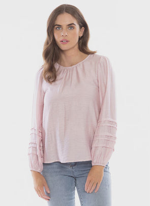The 'nice top' to team up with your jeans. The Milly top is the prettiest blush pink looks fab with your blue denim for an easy casual look or add a blazer to elevate your style. Featuring:  Long sleeve; Pin tuck sleeves Elastic Cuffs Straight hemline Button neck closure