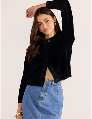 Introducing the Rowan Fluffy Cardi in ivory, a cozy and feminine addition to your wardrobe. Crafted from a super-soft, brushed knit, this timeless cardigan exudes effortless refinement. Wear it over a slip dress, with denim, or pair it with a Mini Skirt for a sophisticated mix of texture and polish.