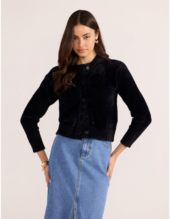 Introducing the Rowan Fluffy Cardi in ivory, a cozy and feminine addition to your wardrobe. Crafted from a super-soft, brushed knit, this timeless cardigan exudes effortless refinement. Wear it over a slip dress, with denim, or pair it with a Mini Skirt for a sophisticated mix of texture and polish.
